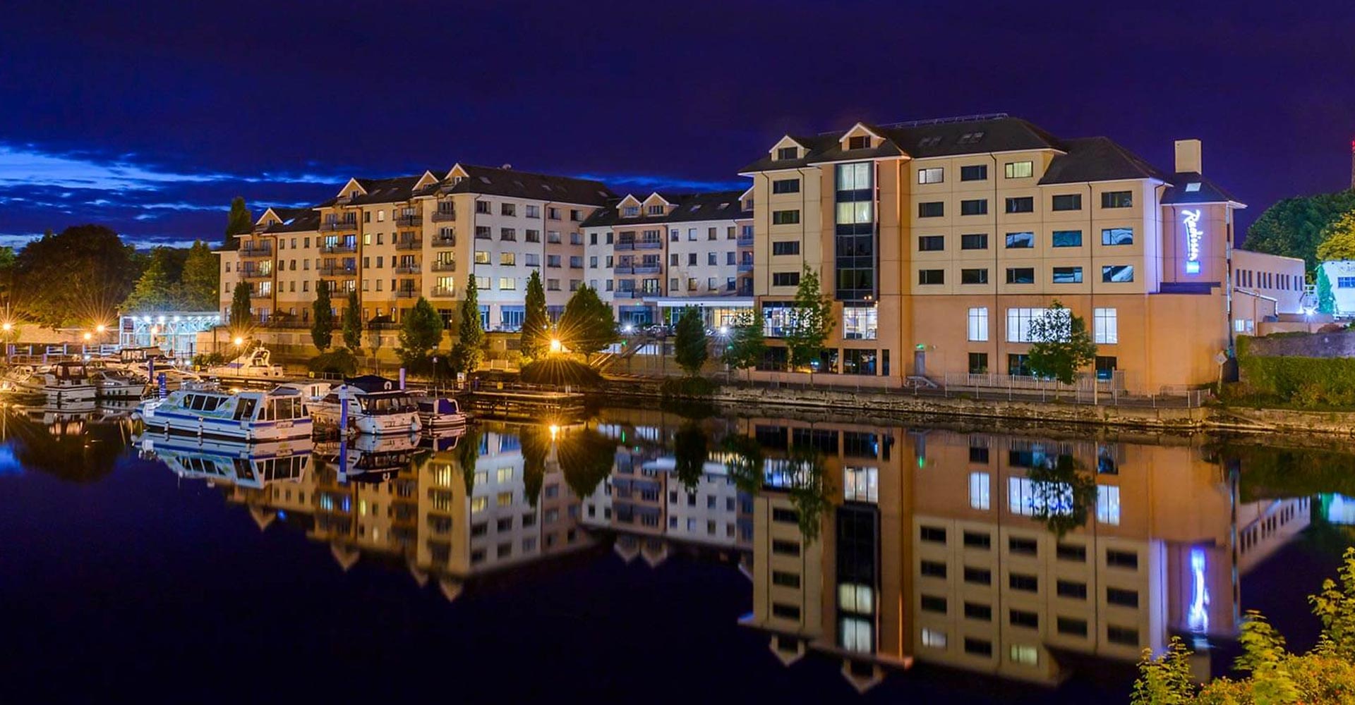 Exterior of Radisson Blu Hotel Athlone from across the water.